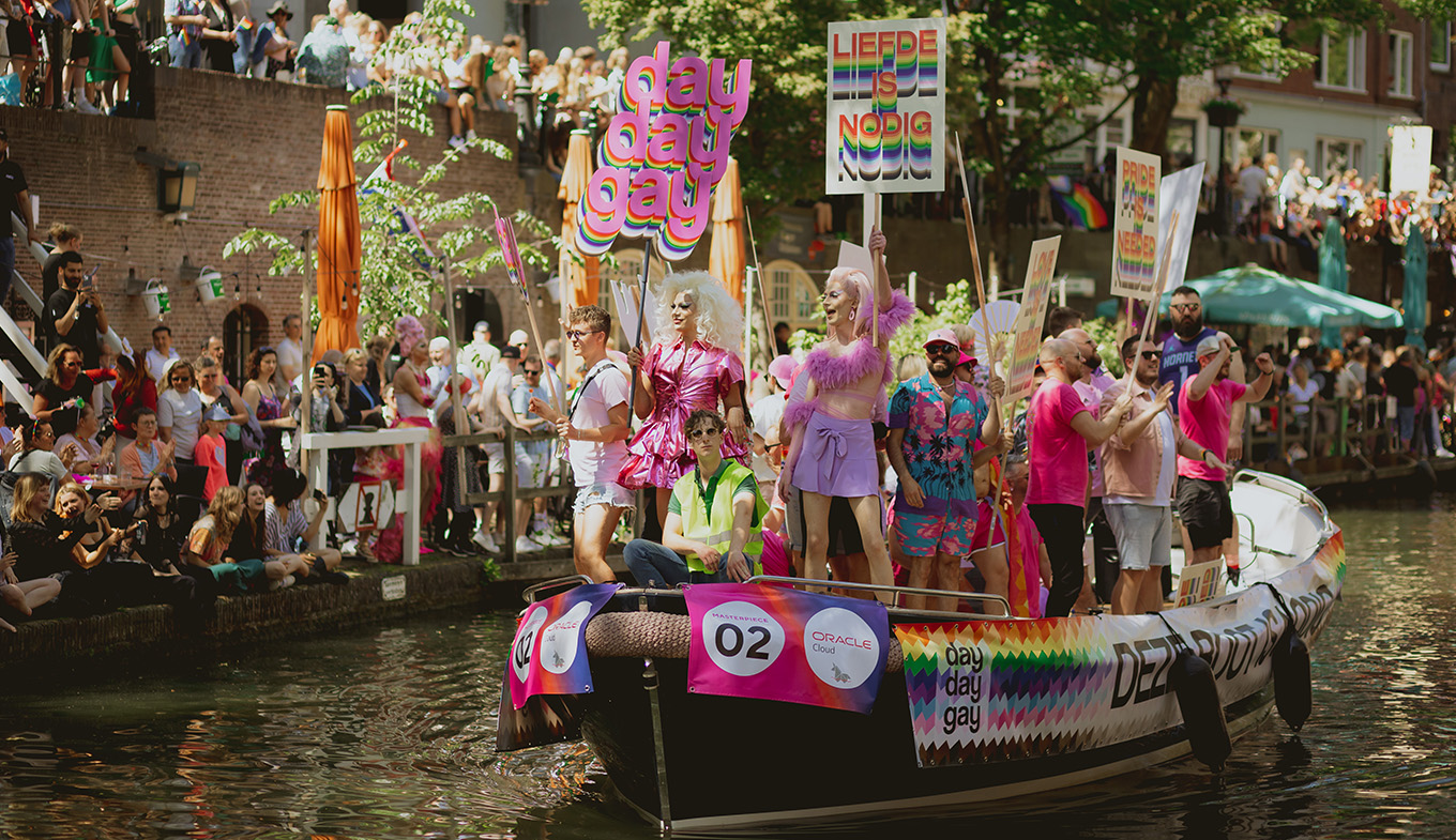 Utrecht Pride boat through canal with sign Love is needed